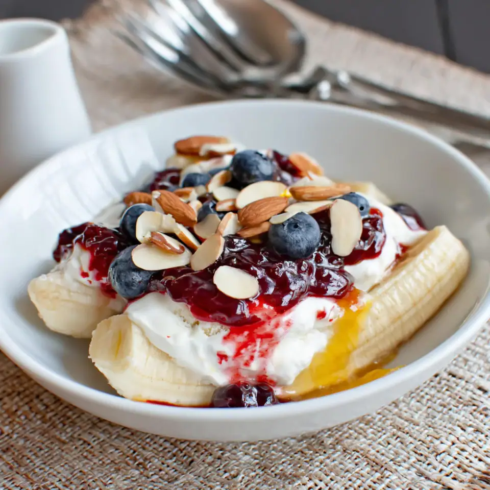 Breakfast Banana Split with Yogurt and Jam served on the table