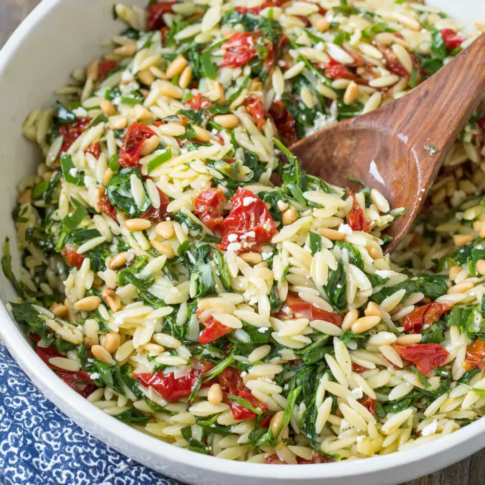 Orzo Salad with Spinach and Feta served on the table