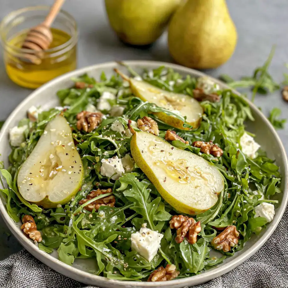 Pear and Arugula Salad with Honey Vinaigrette, ready to serve