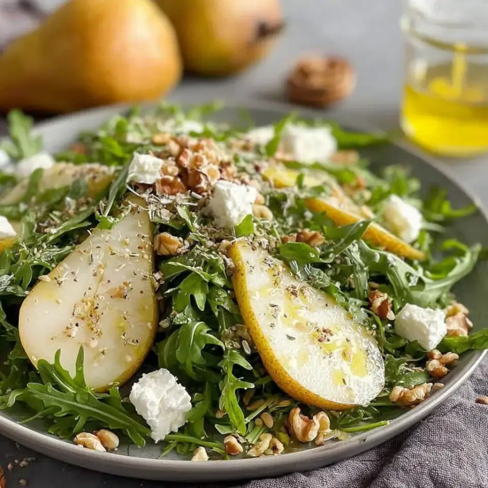 Pear and Arugula Salad with Honey Vinaigrette served on the table