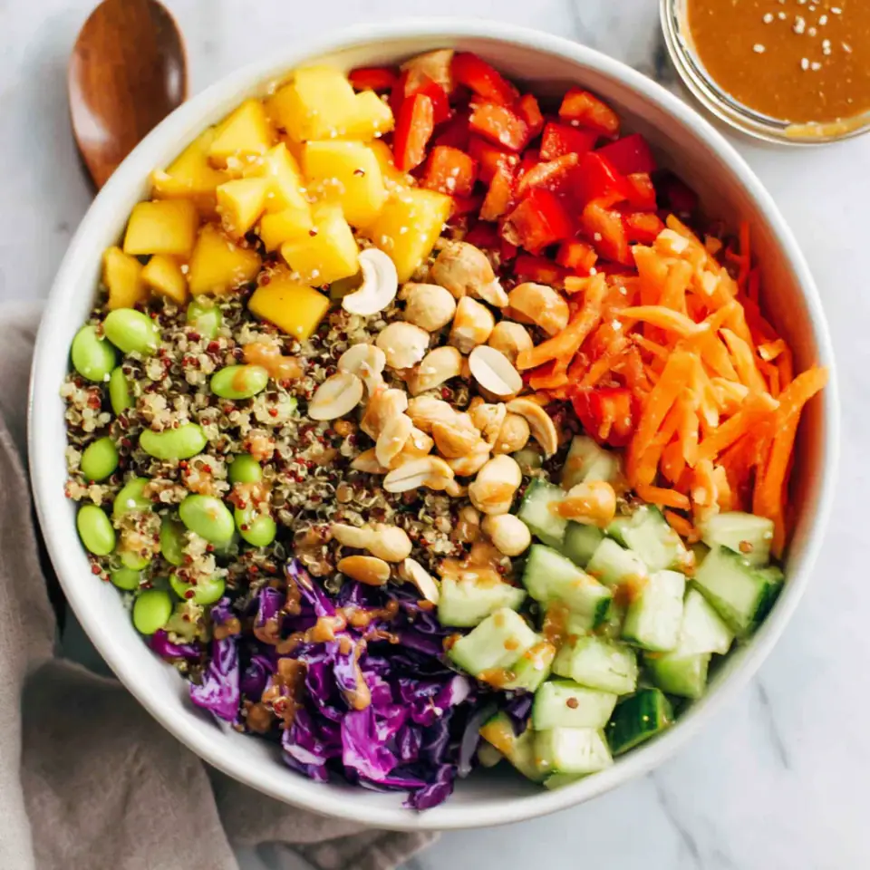 Quinoa Crunch Salad with Peanut Dressing served on the table