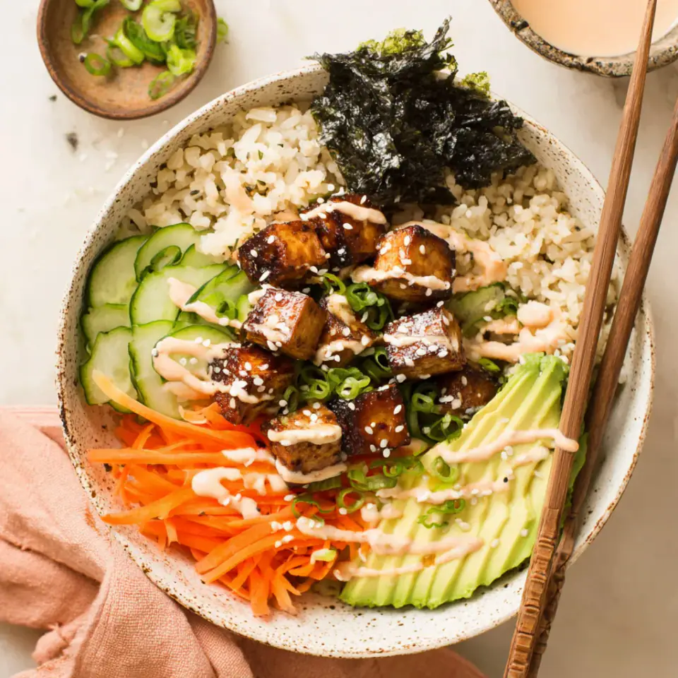 Vegan Sushi Bowls with Sesame Baked Tofu served on the table